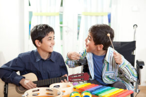 Two boys play music together